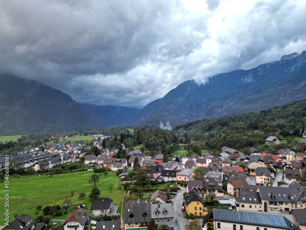 Obraz premium scenic view of bovec slovenia, small european village in the julian alps with beautiful mountains (aerial drone birds eye view looking down) mountain landscape hills outdoor adventure soca valley