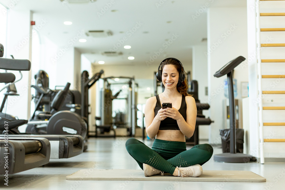 Engaging in mindfulness through a workout playlist in a modern gym setting Engaging in mindfulness through a workout playlist in a modern gym setting