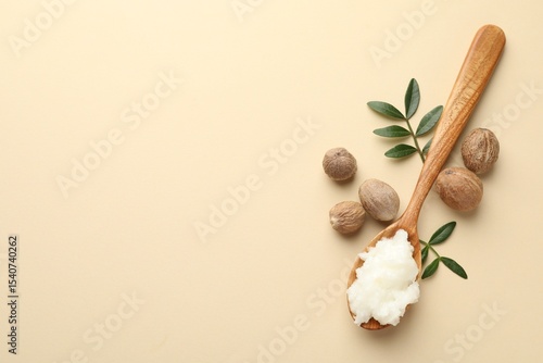 Fotografie She butter, nuts and leaves on beige background, flat lay
