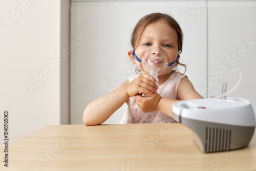 Принти на полотні cute little toddler girl inhaling medicine on nebulizer, portable inhaler for ho