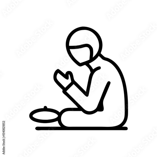 Person praying silently while sitting beside a plate of food for Thanksgiving  