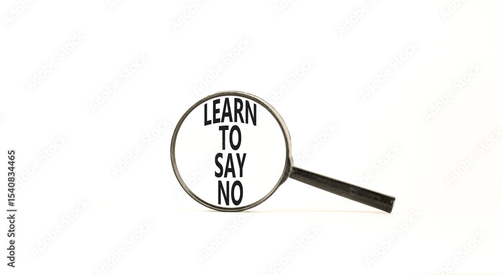 Learn to say no symbol. Concept words phrase Learn to say no in beautiful black magnifying glass. Beautiful white background. Business psychological Learn to say no concept. Copy space. Learn to say no symbol. Concept words phrase Learn to say no in beautiful black magnifying glass. Beautiful white background. Business psychological Learn to say no concept. Copy space.