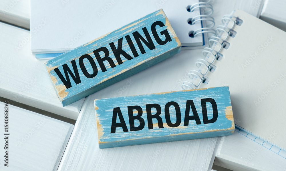 Two wooden signs that say working and abroad Two wooden signs that say working and abroad