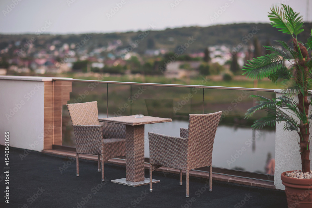 Fototapeta premium Serene evening on a modern balcony overlooking tranquil waters and a lush landscape, inviting relaxation and contemplation at dusk