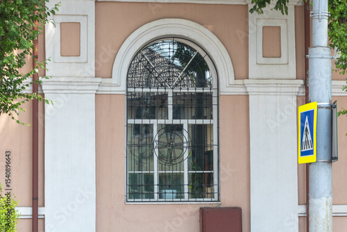 A window with an arched shape on the side of a building