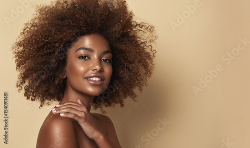 Beauty portrait of african american woman with clean healthy skin on beige background. Smiling dreamy beautiful afro haitstyle  girl.Curly black hair