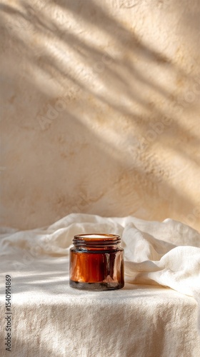 Natural Skincare Product Placed Elegantly on Neutral Fabric With Dried Plants...