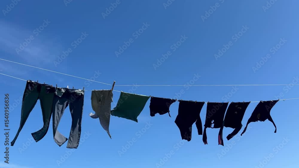 12-second video of casual clothes swaying gently on a clothesline under clear blue sky, symbolizing simple living, sustainability, and eco-friendly drying.
12-second video of casual clothes swaying gently on a clothesline under clear blue sky, symbolizing simple living, sustainability, and eco-friendly drying.