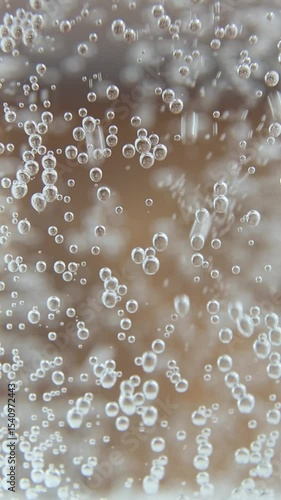 Continuous stream of effervescent water creates dynamic bubble patterns as carbonation rises upward producing hypnotic visual effects ideal for ASMR content and relaxation