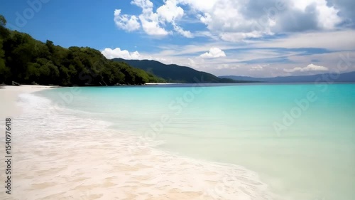 Wallpaper Mural Idyllic tropical scenery with azure ocean, sandy beach, horizon views, and blue sky with fluffy white clouds creating serene seascape. Torontodigital.ca