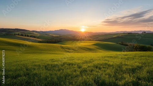 Rolling hills at sunrise. Lush green fields meet the horizon