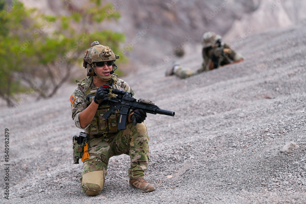 Fototapeta premium Special forces soldier uses a radio during a tactical operation while red flare smoke spreads across the rocky ground. Team communicates under high-alert battlefield conditions.