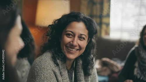 Latina Woman Smiles in Casual Conversation with Friends Indoors