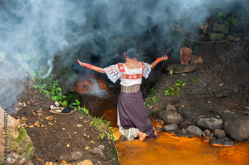 Mayan priestess performing ritual in sacred cenote