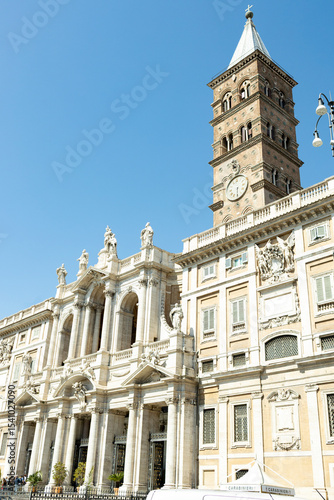 View of the Papal Basilica of Santa Maria Maggiore and its clock, from Piazza Santa Maria Maggiore, on a sunny day.