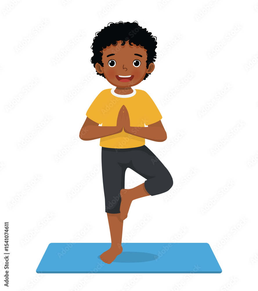 Fototapeta premium Little African boy doing yoga pose on a green mat at home 