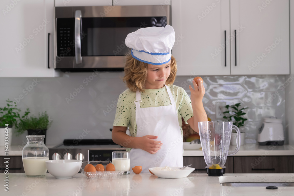 Kid chef cook cookery. Cooking children. Child boy with apron and chef hat preparing a healthy meal in the kitchen. Cooking process. Kid chef cook cookery. Cooking children. Child boy with apron and chef hat preparing a healthy meal in the kitchen. Cooking process.