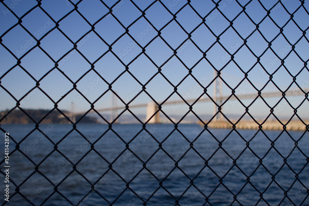 Fototapeta premium chain fence with bridge in background
