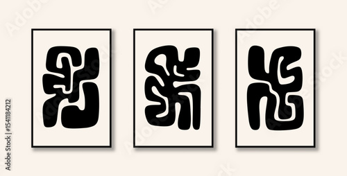 Three creative artistic paintings with abstract pictograms with organic fluid shapes, in black color displayed on the wall