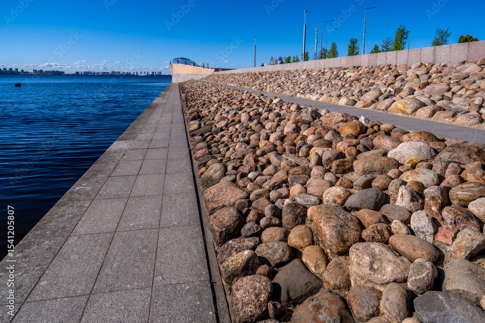Fototapeta premium The embankment along the river is fortified with stones.