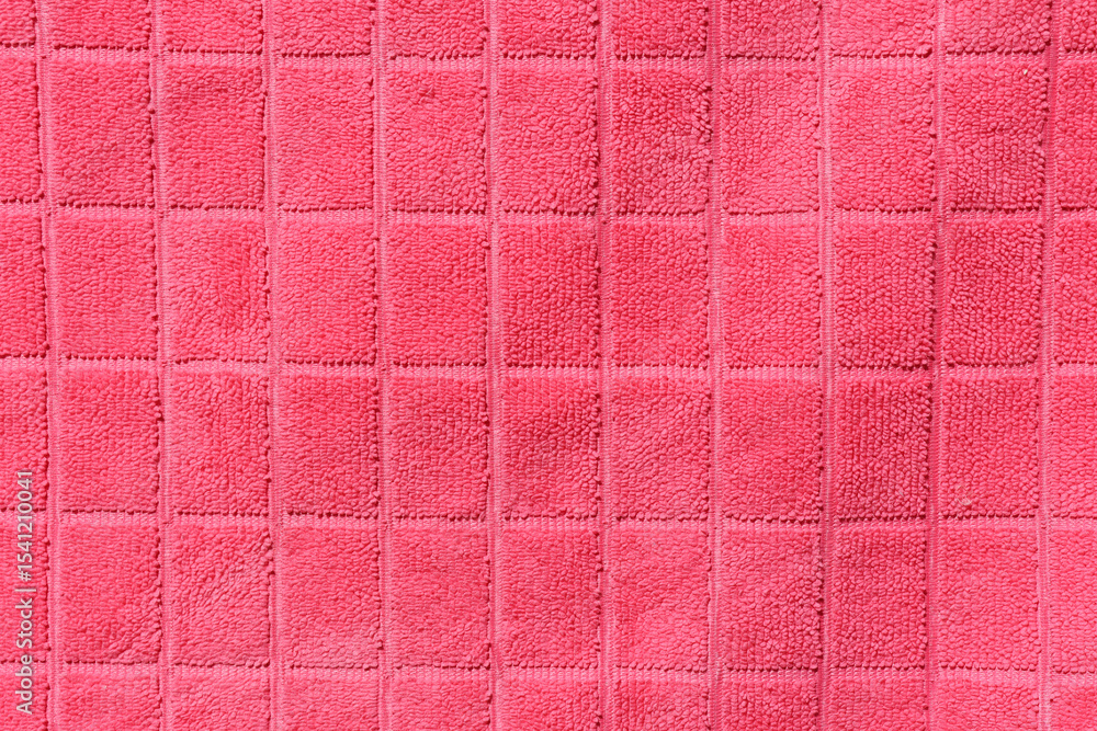 Fototapeta premium Pink fabric with a grid pattern close-up abstract textured background