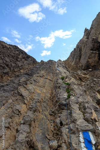 Ascent with via ferrata and steel cable towards mountain Col des Chamois in Swiss Alps, Switzerland
