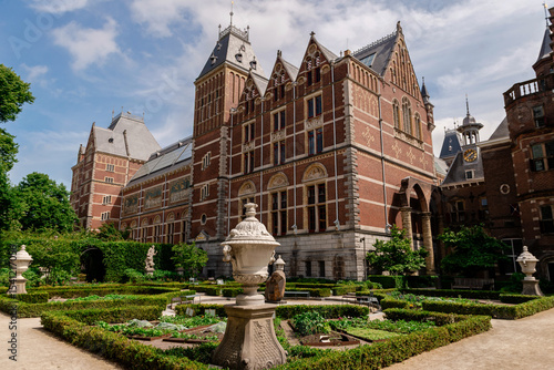 Amsterdam, Netherlands – May 21, 2025: Rijksmuseum old museum building and garden in a sunny day.