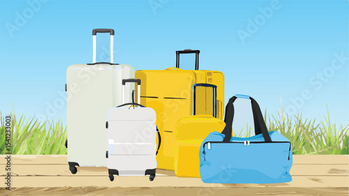 A group of suitcases and a duffel bag are arranged on a wooden surface against a blue sky background