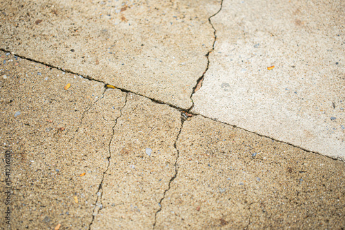 Close up shot of concrete floor with oblique linear cracking, in light brown and grey color, retro style