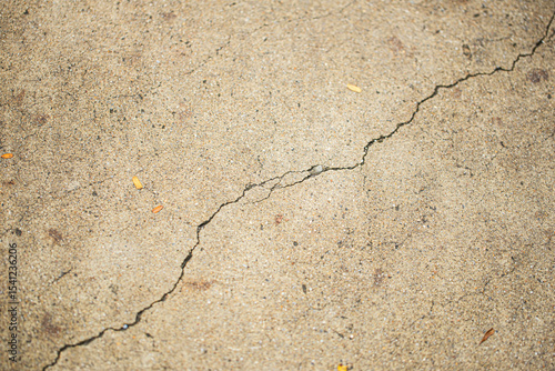 Close up shot of concrete floor with oblique cracking, in light brown color, retro style