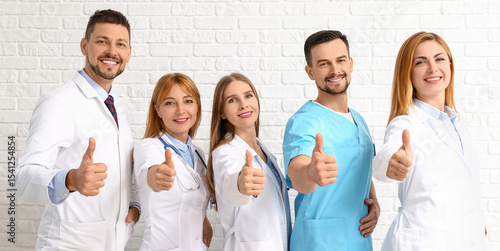 Team of doctors showing thu...