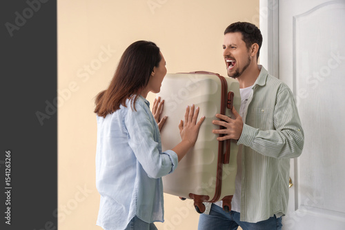 Angry husband kicking his w...