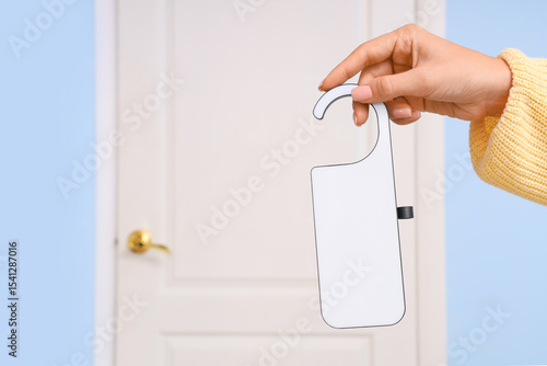 Woman with door hanger in h...