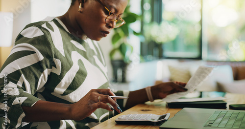 Photos Calculator, home and black woman with documents, financial profit and budget with invoice