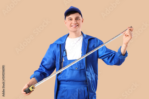 Male worker with tape measu...