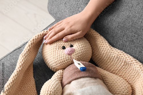 Female hand and toy bunny w...