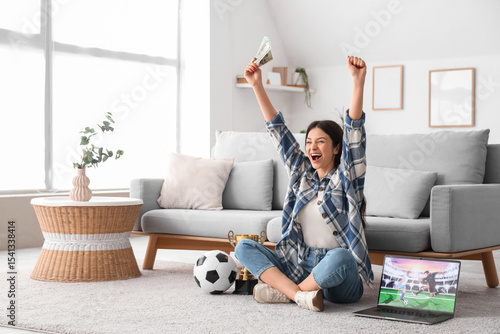 Happy young woman with mone...