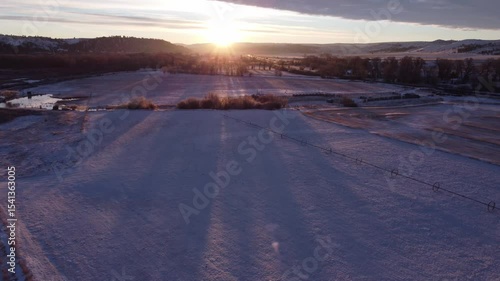 Sunrise over farm fields in winter 
