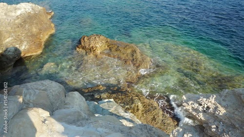 Rocky coastline of Mediterranean sea on Crete, Greece. Blue, clear water.