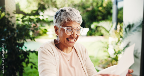 Photos Senior, happy woman or winning with receipts for tax return, deduction or finance at home