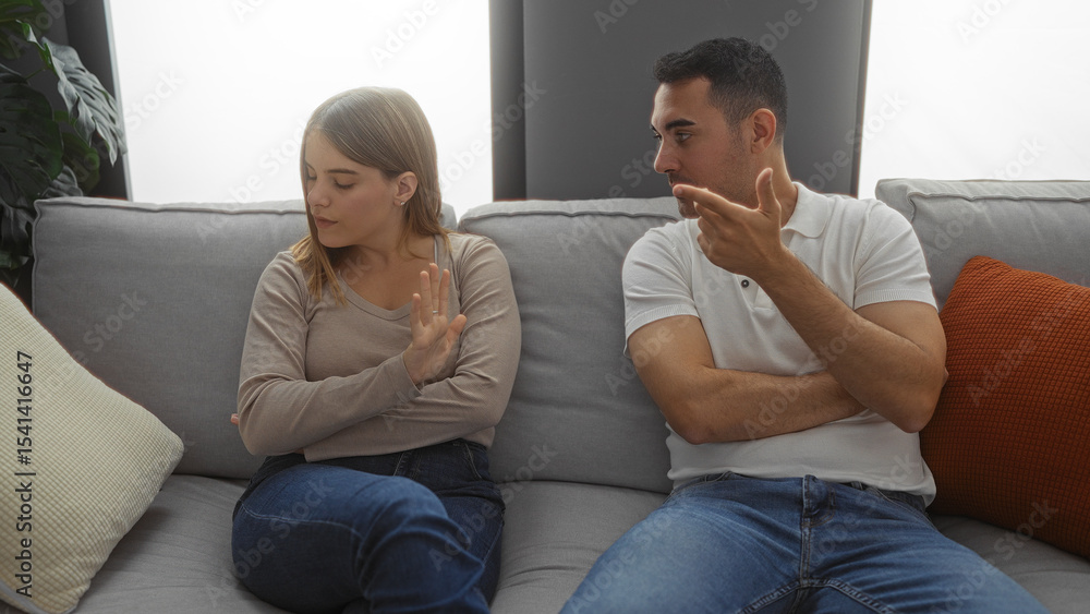 Man and woman sitting in living room on couch discussing relationship issues indoors in cozy apartment setting showing emotion and human connection. Man and woman sitting in living room on couch discussing relationship issues indoors in cozy apartment setting showing emotion and human connection.