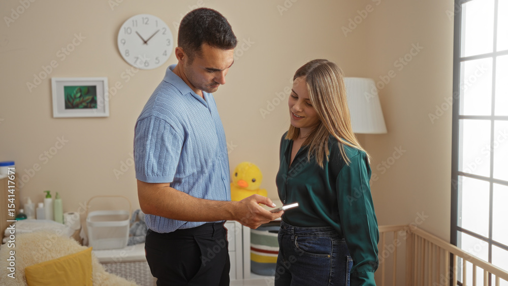 Fototapeta premium Hispanic couple in bedroom looking at phone near baby crib, showcasing love and family in cozy home setting, surrounded by warm interior decor.