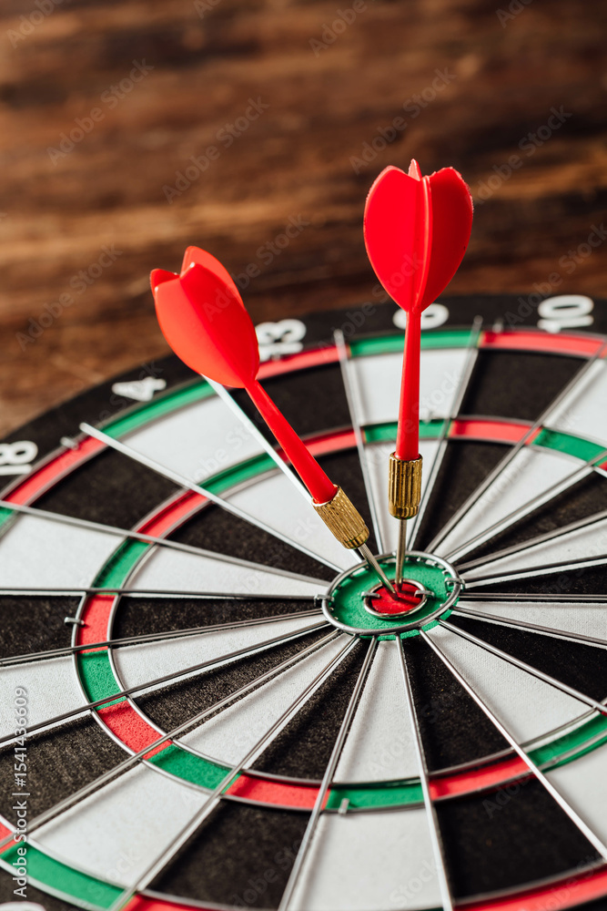 A Close-Up of Red Darts Hitting the Bullseye on a Dartboard A Close-Up of Red Darts Hitting the Bullseye on a Dartboard