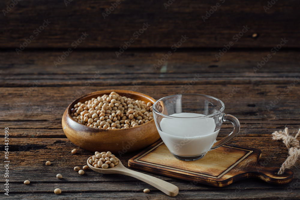 Fresh Soy Milk in Glass Cup with Soybeans on Rustic Wooden Table Fresh Soy Milk in Glass Cup with Soybeans on Rustic Wooden Table