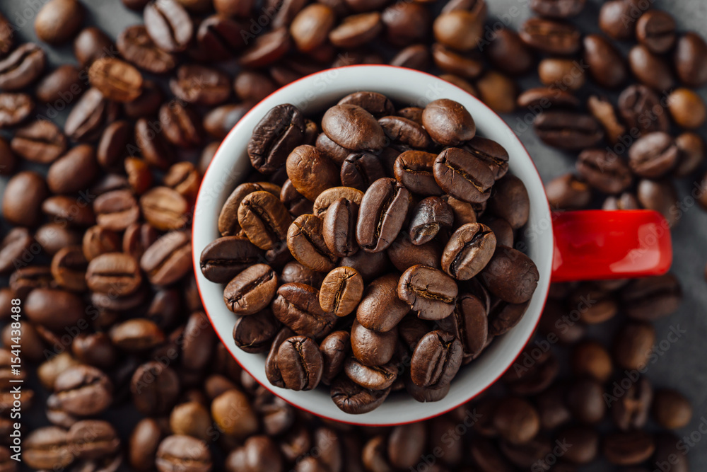 Fototapeta premium Close-Up of Freshly Roasted Coffee Beans in Red Cup on Table