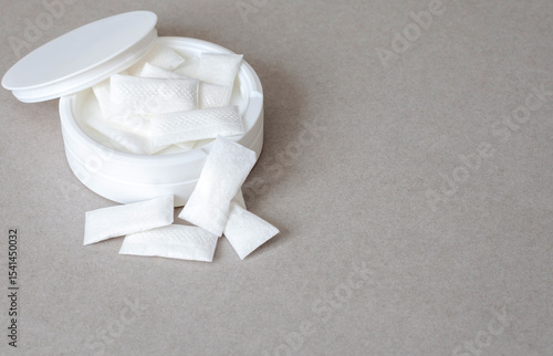 white container of Nicotine pouches on grey