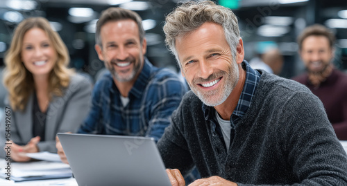 happy business people working together on laptop