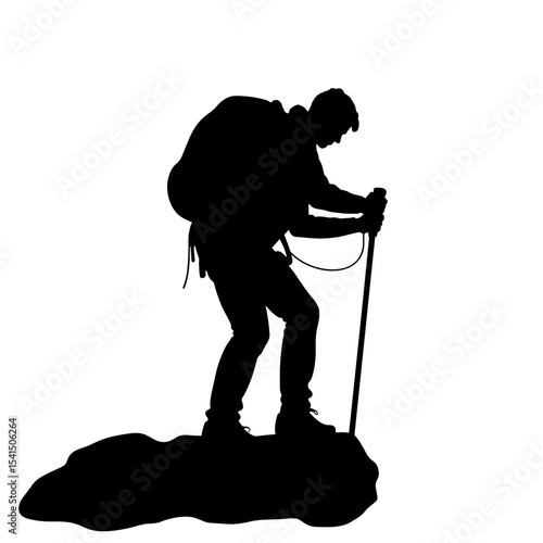 Silhouette of hiker using trekking pole on rocky terrain  