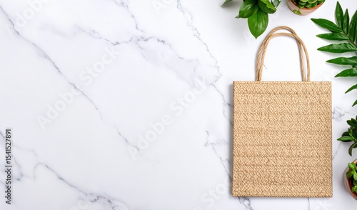 Beige Woven Tote Bag with nature plants on marble Background with copy space
