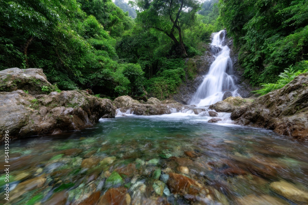 Fototapeta premium Waterfall cascading through lush greenery in a serene natural landscape